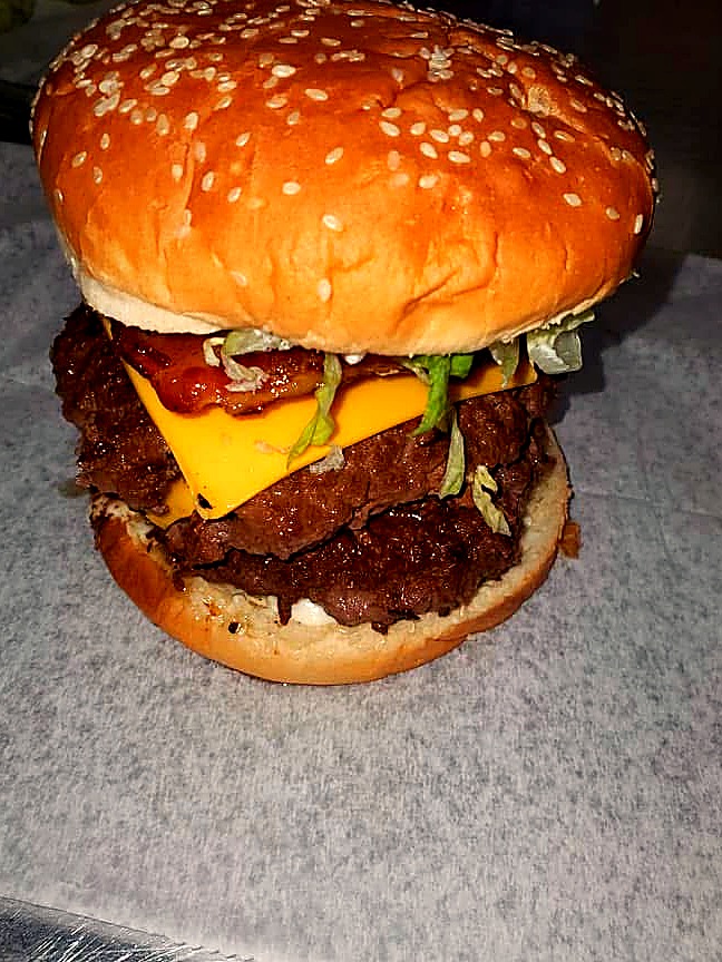 Tony's hand-pattied double cheeseburger fresh off the griddle